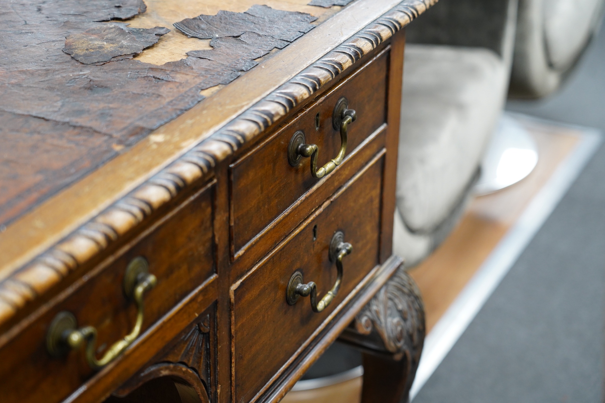 An early 20th century Chippendale Revival mahogany kneehole writing table, width 136cm, depth 75cm, height 76cm. Condition - fair (leather-poor)